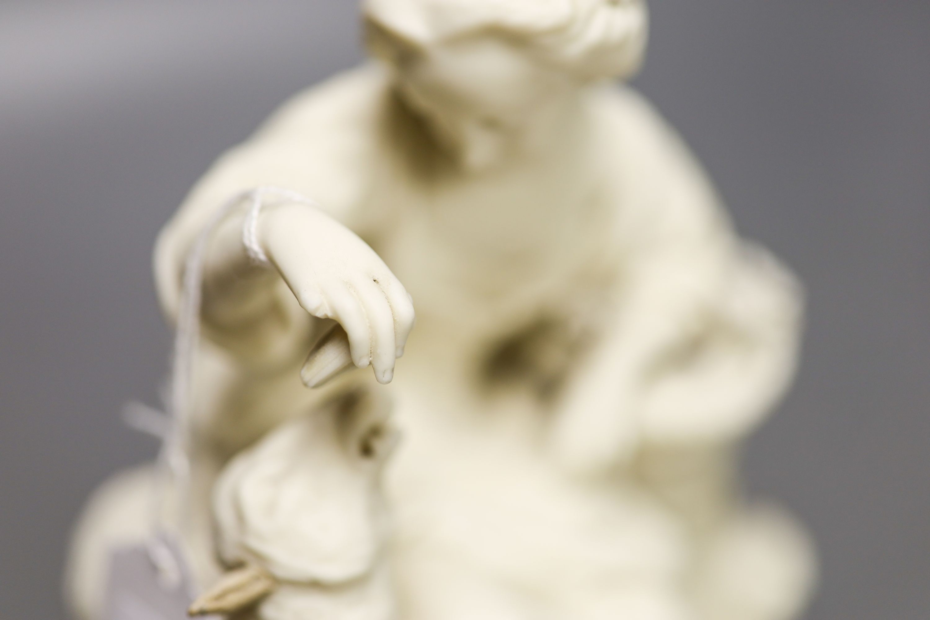 A Samuel Alcock parian group of a maid and sheep, a similar Minton biscuit group and a Samson porcelain group in Derby style Tallest 27cm